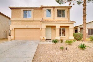 A two-story house with a garage, a small front yard with gravel and plants, and a palm tree. - Patio & Community Perks! San Tan Mountain Retreat (San Tan Valley)
