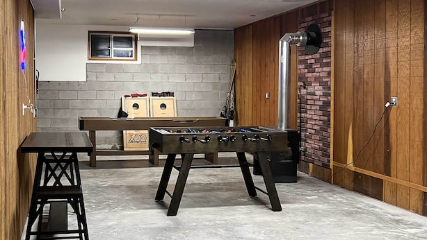 A room with a foosball table, a small bench, and a window. - Cabin w/ Hot Tub, By Crater Lake Nat'l Park! (Klamath Falls)