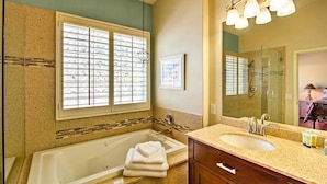 A bathroom with a large bathtub, a sink, and a shower. - Tucson Home W/pool & Santa Catalina Mtn Views (Tucson)