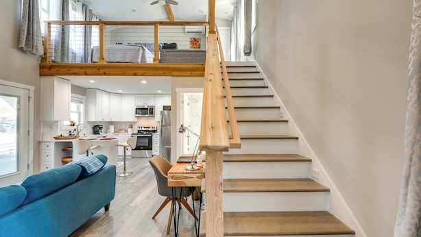 Een modern interieur met een trap, een eethoek en een keuken.