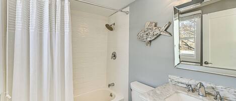 Un baño con bañera, inodoro y lavabo.