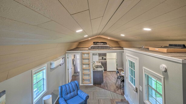 A compact, multi-level living space with a loft bedroom, kitchen, and seating area. - Quaint Montezuma Cabin Near Lake Ponderosa! (Montezuma)