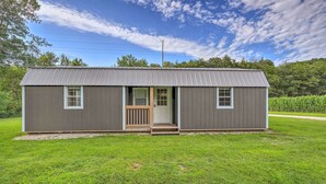 A small, single-story building with a metal roof and a front porch. - Quaint Montezuma Cabin Near Lake Ponderosa! (Montezuma)
