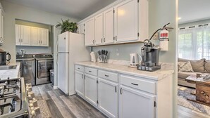 A modern kitchen with white cabinets, stainless steel appliances, and a coffee maker. - Bayville Getaway w/ Fire Pit - 2 Mi to Beach! (Bayville)