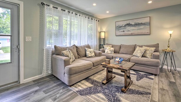 A living room with a sectional sofa, a coffee table, and a rug. - Bayville Getaway w/ Fire Pit - 2 Mi to Beach! (Bayville)