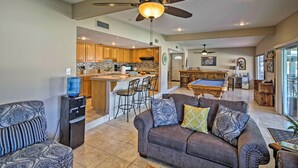 A spacious living area with a sofa, a water dispenser, and a pool table in the background. - Waterfront Home in Parker w/ Mtn Views & Dock! (Parker)