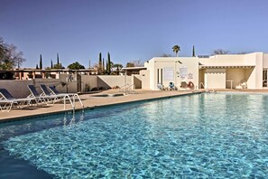 A swimming pool with clear water, sun loungers, and a covered area with a sign. - Green Valley Townhome w/ Patio & Resort Amenities (Green Valley)