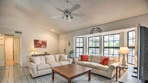 A spacious living room with two sofas, a coffee table, and a TV stand. - 1 Mi to Golf! Family-friendly Sun City West Home (Sun City West)