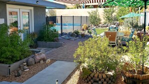 A backyard with a swimming pool, patio furniture, and potted plants. - 4 Mi to Beach: Lake Havasu Apartment w/ Pool! (Lake Havasu City)