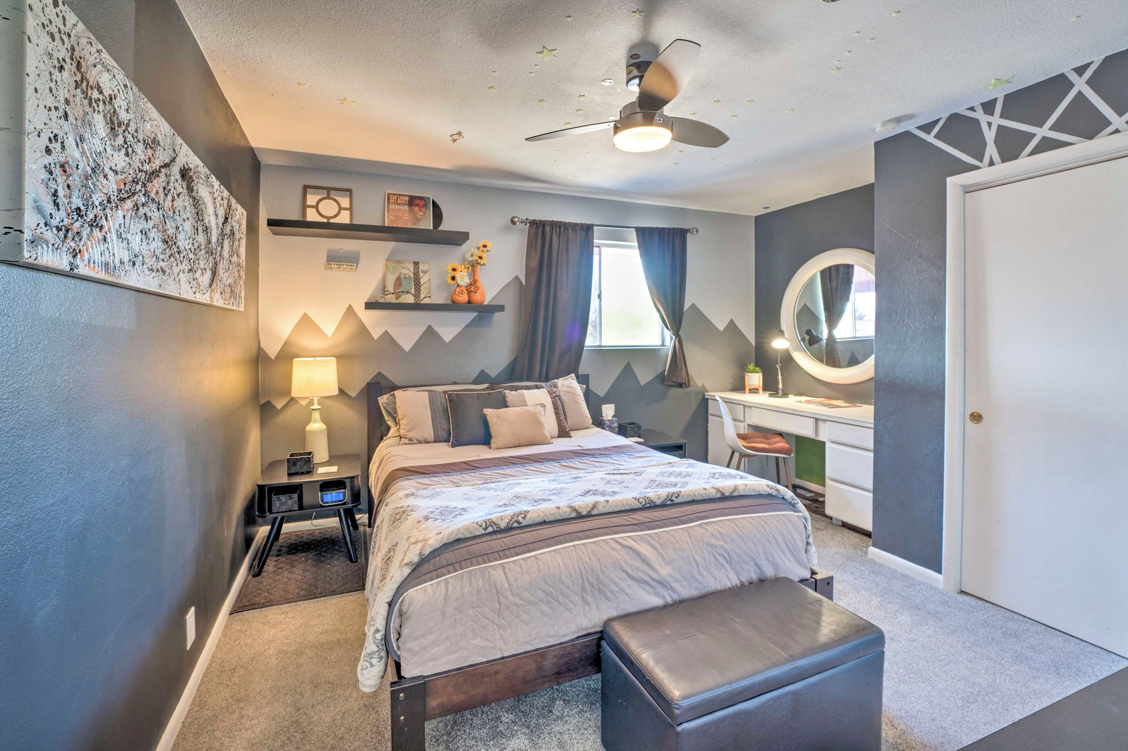 A bedroom with a bed, bedside table, lamp, and a desk with a chair. - 4 Mi to Beach: Lake Havasu Apartment w/ Pool! (Lake Havasu City)