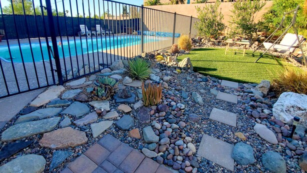 A backyard with a swimming pool, surrounded by a black metal fence. - 4 Mi to Beach: Lake Havasu Apartment w/ Pool! (Lake Havasu City)