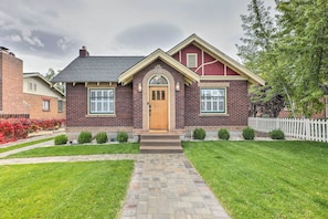 A two-story brick house with a central entrance, a small front porch, and a white picket fence. - Reno Home < 1 Mile to Midtown & Truckee River (Reno)