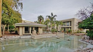 A hotel courtyard with a swimming pool, outdoor seating, and palm trees. - Walk to Fashion Park! Phoenix Abode w/ Pool Access (Phoenix)