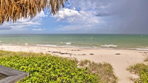 A beach with clear skies and calm waters. - Jensen Beach Home: Walk to Beach Access! (Jensen Beach)