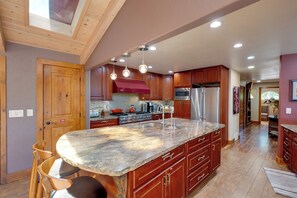 A spacious kitchen with a large island, wooden cabinets, and a skylight. - Game Room! Group Lake House, 25 Mi to Yosemite (Groveland)