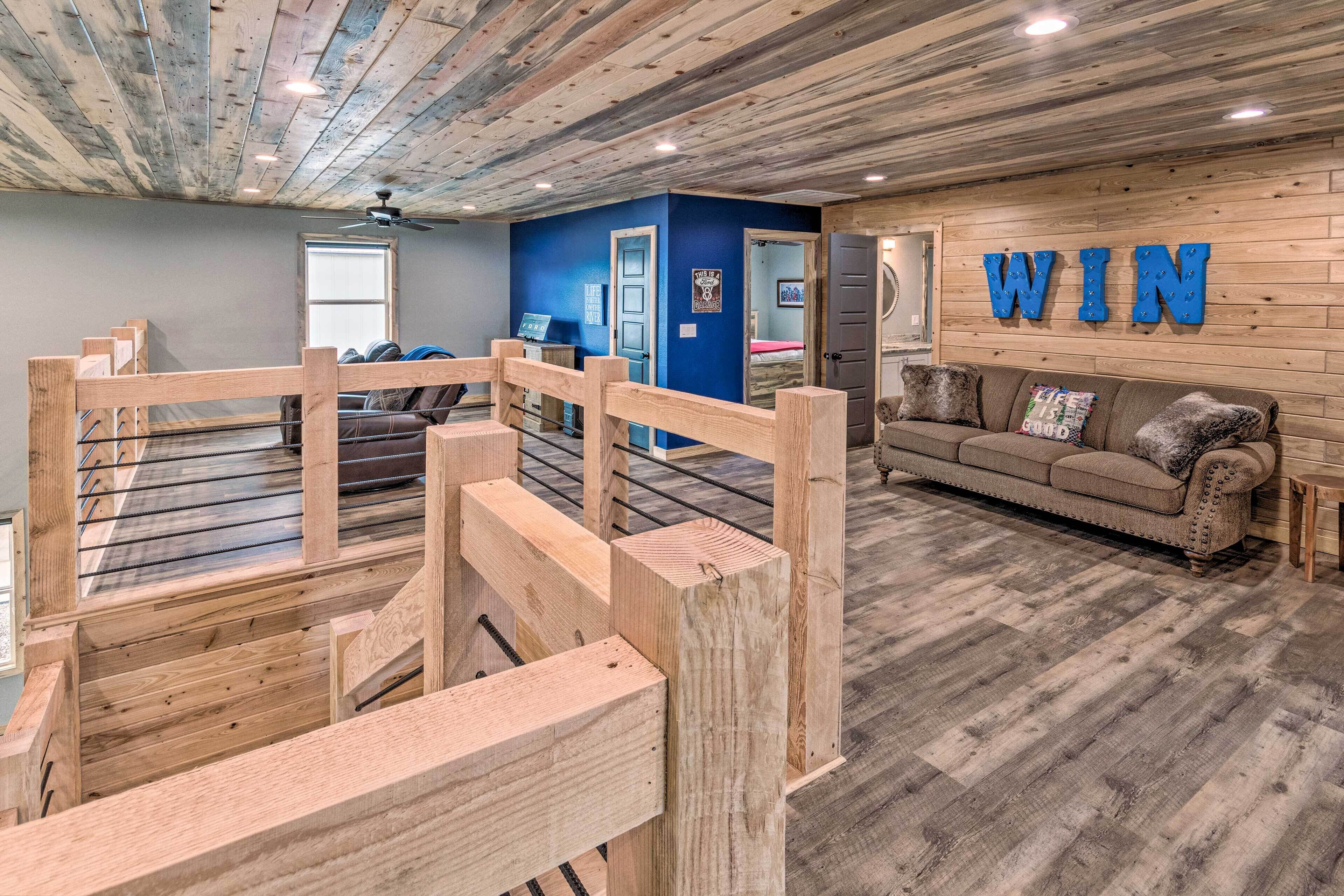 A room with a wooden ceiling, a blue wall, a sofa, and a 'WIN' sign.