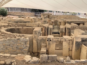 Ancient ruins with stone walls and a central staircase.
