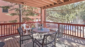 A wooden deck with a round table and chairs, overlooking a snowy landscape and trees. - Angel Fire Condo w/ Fireplace < 1 Mi to Ski Resort (Angel Fire)