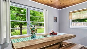 A wooden bench table with a checkered tablecloth, a vase with flowers, and a toy car. - Great Smoky Mountains Retreat w/ Fire Pit & Views! (Sevierville)