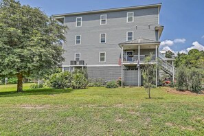 A two-story building with a balcony and a small porch. - Family Beach Home; Walk to N Litchfield Beach (Pawleys Island)