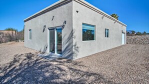 A modern, single-story building with a flat roof, large windows, and a gravel driveway. - Tucson Vacation Rental ~ 5 Mi to Nat'l Park (Tucson)