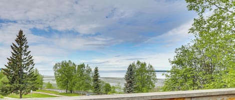A wooden deck with a view of a lake and trees.