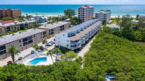 A resort with a pool, beachfront view, and multiple buildings. - Heated Pool, Steps to Beach: Indian Shores Condo! (Indian Shores)