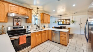 A modern kitchen with wooden cabinets, stainless steel appliances, and a central island. - Yuma Vacation Rental w/ Private Pool & Patio! (Yuma)