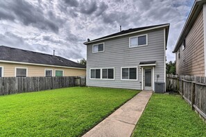 A two-story house with a well-maintained lawn and a wooden fence. - Houston Family Home w/ Yard ~ 8 Mi to NRG Stadium! (Houston)