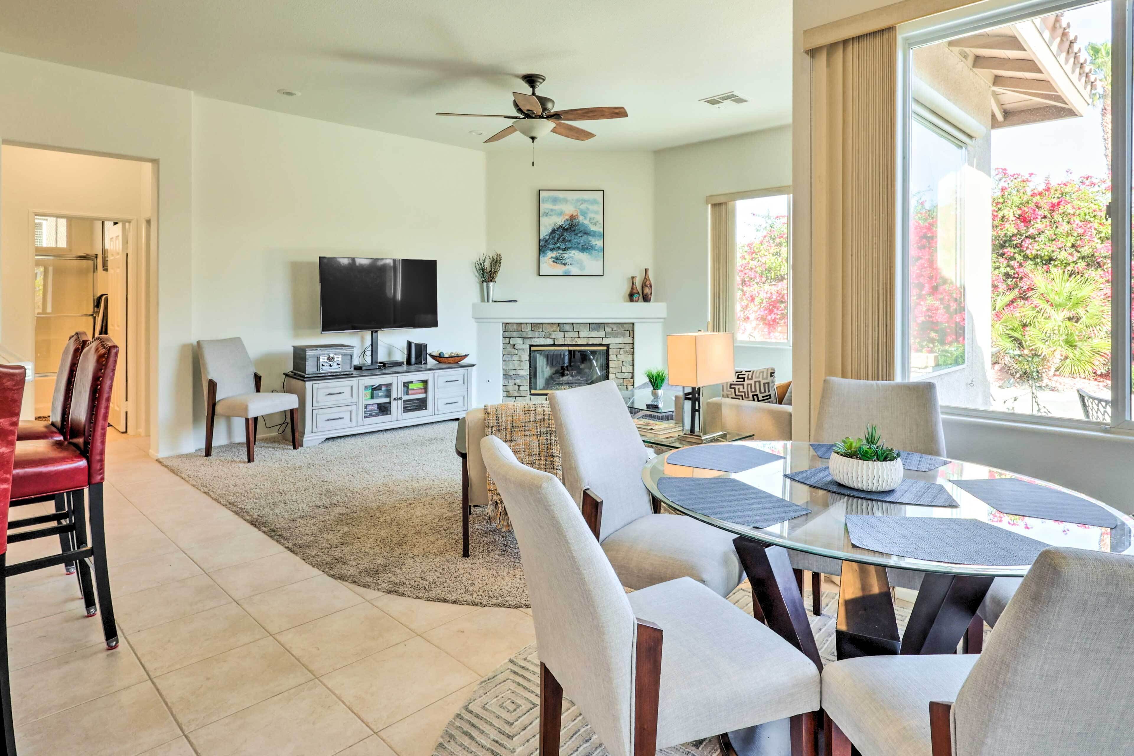 A modern living room with a fireplace, television, and dining area.