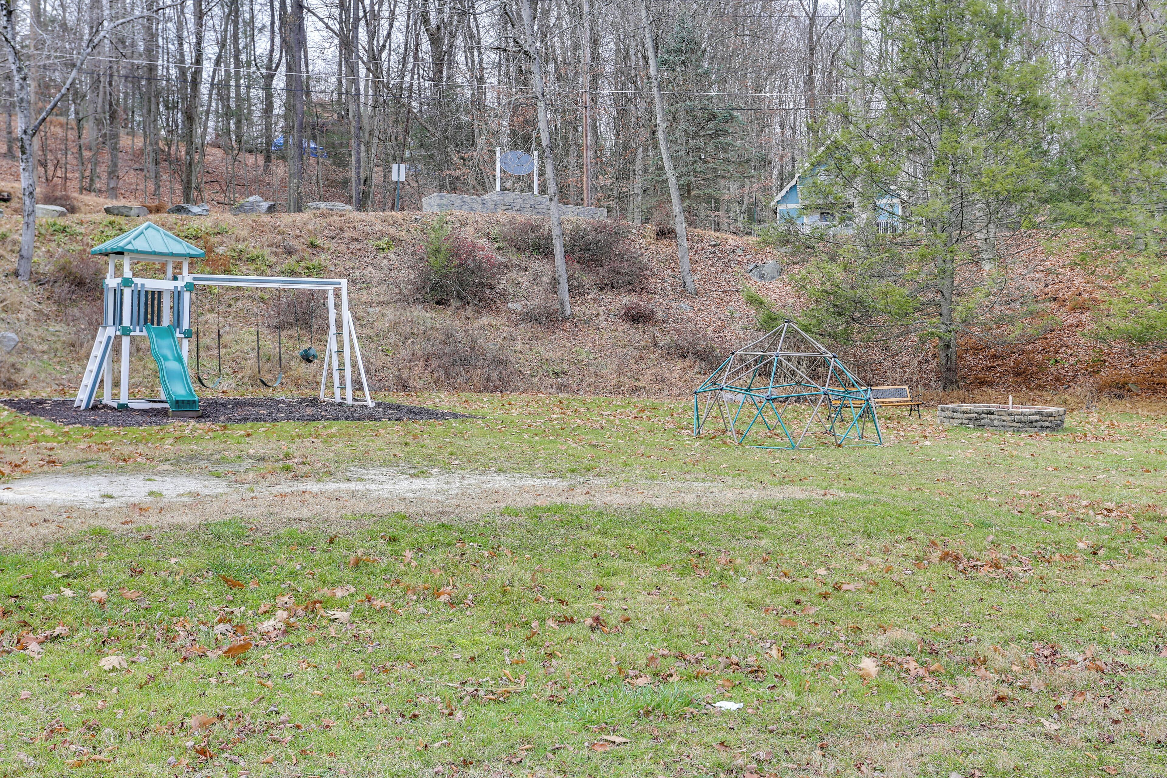 A playground with a swing set and a climbing structure.