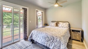 A bedroom with a large bed, a ceiling fan, and a sliding glass door leading to a deck. - Cozy North Bend Getaway Near Dunes + Ocean! (North Bend)
