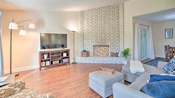 A living room with a fireplace, a television, and a sofa.