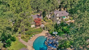 An aerial view of a residential property with a swimming pool, a house, and surrounding greenery. - Lavish Sonora Suite on 10 Acres w/ Shared Pool! (Sonora)