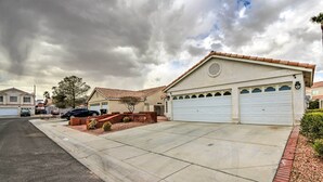 A residential house with a garage, a driveway, and a street. - Pet-friendly Escape w/ Grill, 11 Mi to Strip! (North Las Vegas)
