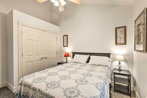 A bedroom with a bed, two bedside tables with lamps, a wardrobe, and framed pictures on the walls. - 18 Mi to Crystal Mtn: Couple's Haven Near Lake (Frankfort)