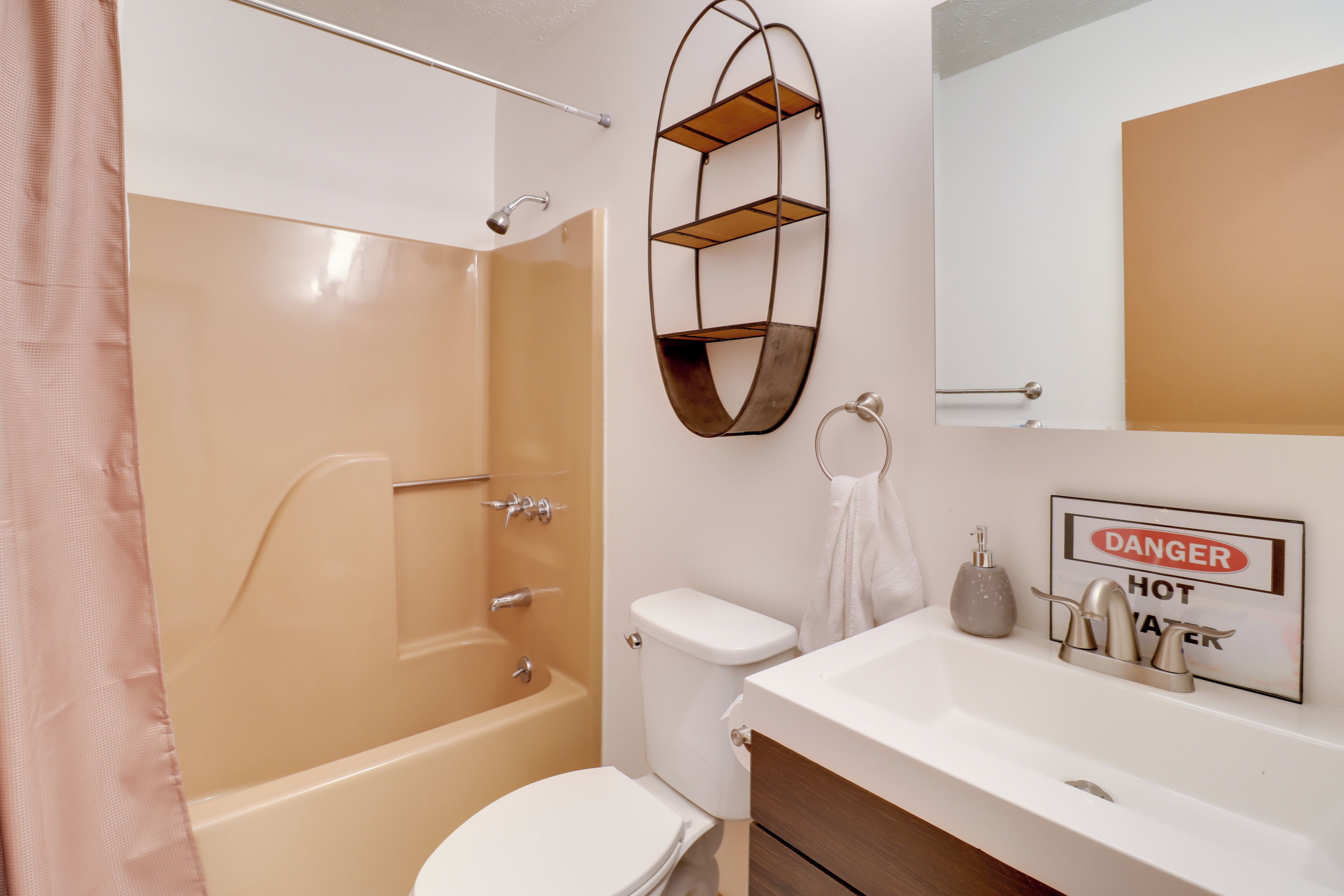A bathroom with a bathtub, toilet, and sink.
