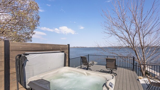 A hot tub on a wooden deck with a view of the water. - Private Sauna, Hot Tub, Beach Lake Poinsett (Lake Norden)