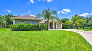 A single-story house with a sloped roof, a front porch, and a well-maintained lawn.