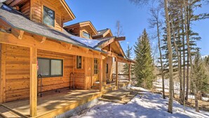 A wooden cabin with a covered porch, multiple windows, and a snow-covered ground. - Rustic Mountain Sanctuary on 2+ Acres w/ Deck! (Alma)