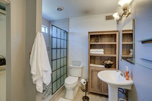 A compact bathroom with a toilet, sink, and glass shower enclosure. - Beautiful Phoenix Vacation Rental w/ Private Pool! (Phoenix)