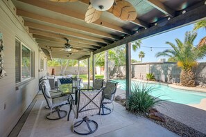 A covered patio area with outdoor furniture, a pool, and a view of the surrounding landscape. - Beautiful Phoenix Vacation Rental w/ Private Pool! (Phoenix)