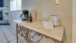 A kitchen counter with coffee-making equipment, a coffee box, and a coffee mug rack. - Beautiful Phoenix Vacation Rental w/ Private Pool! (Phoenix)