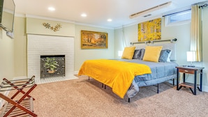 A bedroom with a bed, a fireplace, a painting, and a window. - ~ 10 Mi to Dtwn: Indianapolis Home w/ Game Room! (Indianapolis)