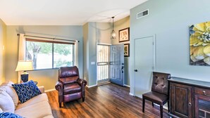 A living room with a sofa, two chairs, a lamp, and a cabinet. - Serene Surprise Home w/ Backyard & Private Pool (Surprise)