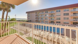 A multi-story hotel with balconies, a pool, and a view of the ocean. - Central Cocoa Beach Condo w/ View, Steps to Beach! (Cocoa Beach)