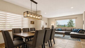 A dining area with a table and chairs, a sofa, and a view of the outdoors. - Hot Tub, 2 Mi to Cabriolet Lift: Family Mtn Escape (Park City)