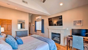 A bedroom with a bed, a TV, a fireplace, and a desk. - Hot Tub, 2 Mi to Cabriolet Lift: Family Mtn Escape (Park City)