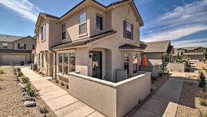 A two-story house with a flat roof, large windows, and a covered patio area. - Modern Washington Home - Pool & Trail Access! (Washington)