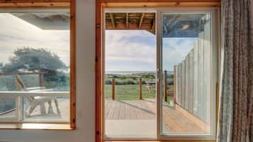 A room with a large sliding glass door leading to an outdoor deck.